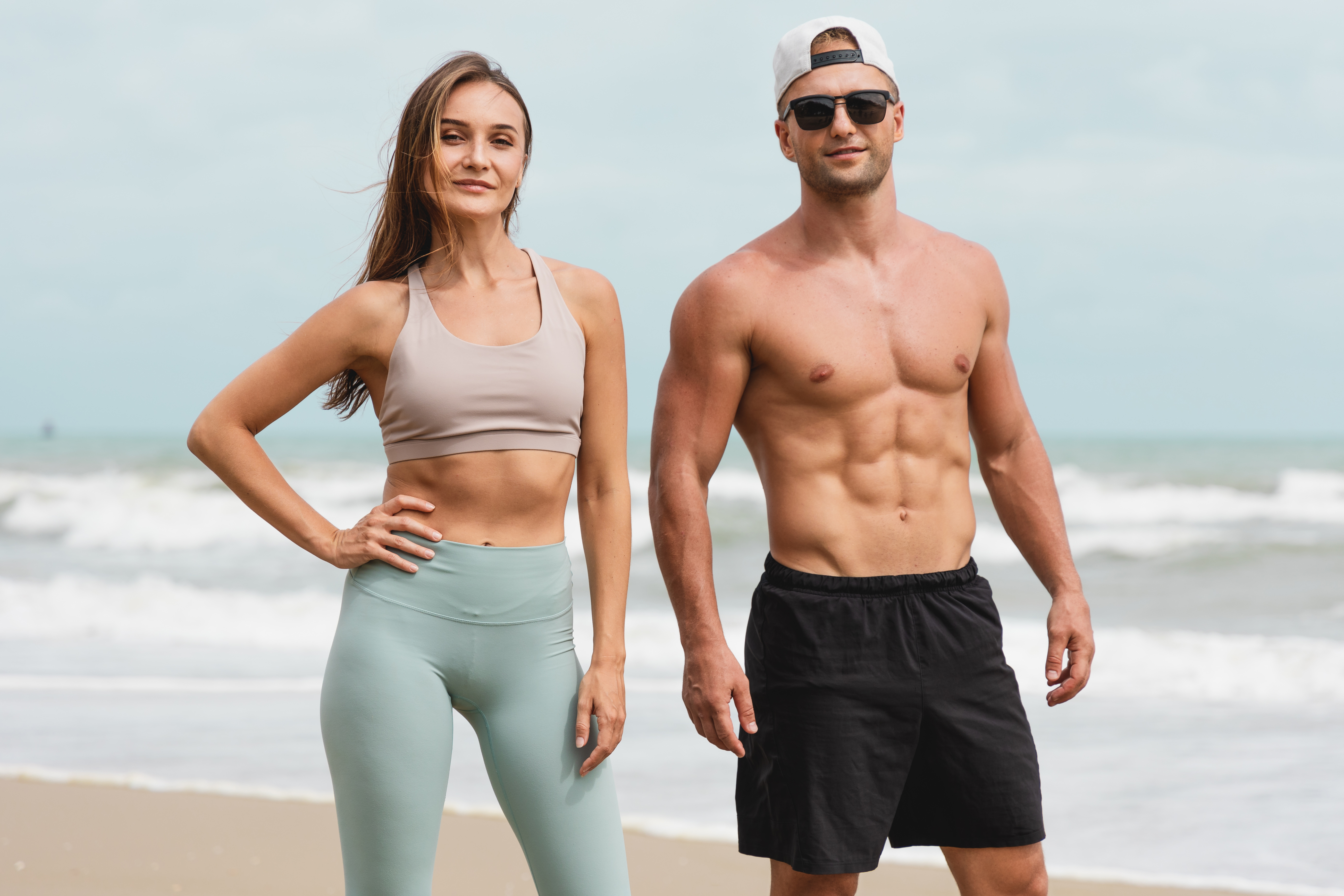 Athletic adults standing together by the ocean